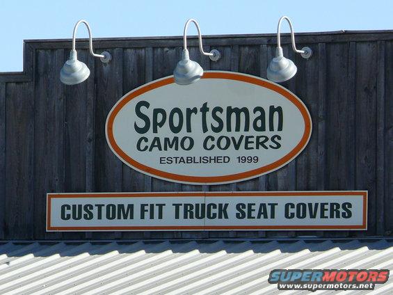 Sign for Sportsman Camo Covers, established 1999, advertising custom fit truck seat covers