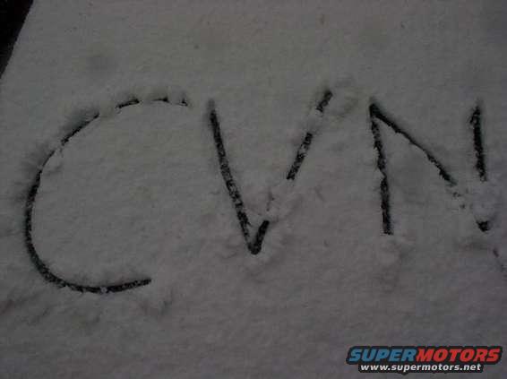 CVN written in snow on a surface, with Supermotors.net watermark at bottom right