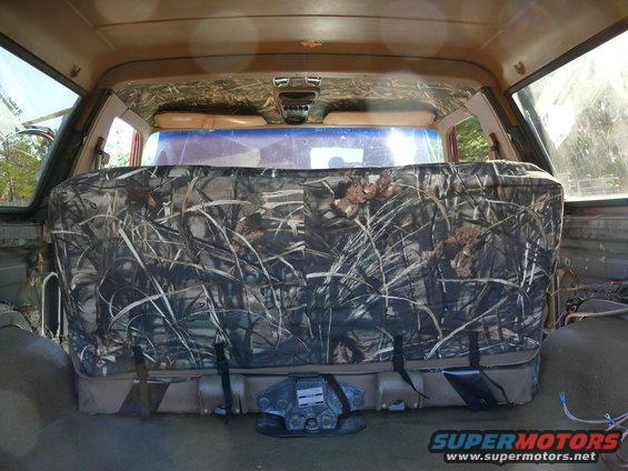 Rear seat with camouflage cover and visible SuperMotors logo