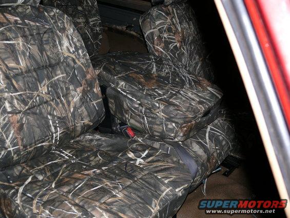 Camouflage seat covers on front seats of a vehicle