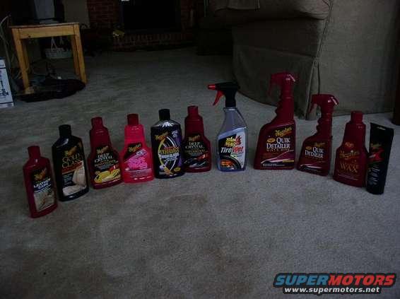 Row of Meguiar's car cleaning bottles and tubes on a carpeted floor
