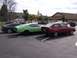 1996 Ford Probe - Multiple vehicles are parked in a lot with buildings and trees in the background.