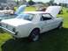 1973 Ford Mustang - White 1965 Ford Mustang coupe with hood up, parked next to a light blue convertible.