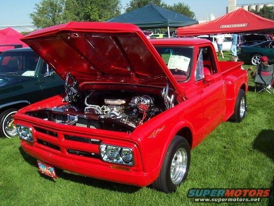 Red pickup truck, hood open, showing engine. Appears to be from the early 1970s
