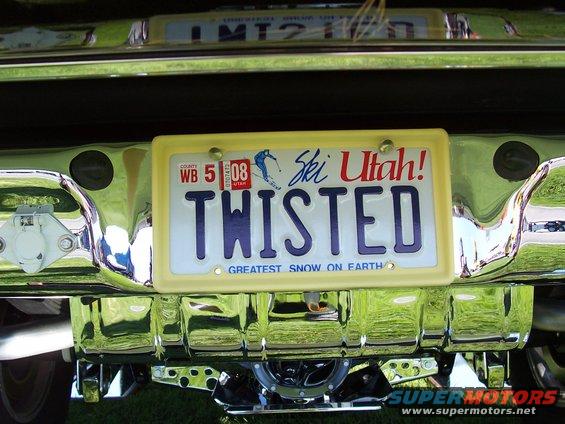 Rear bumper with chrome trim and a yellow license plate frame holding a "TWISTED" Ski Utah plate