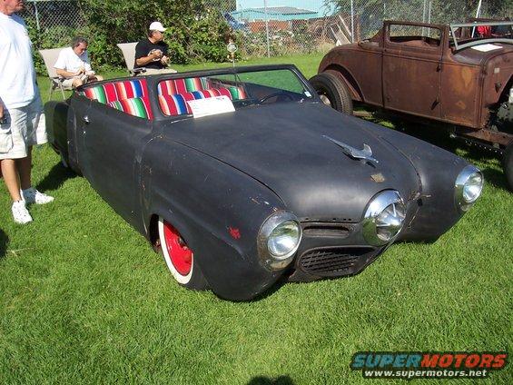 Black convertible with striped interior and red wheels