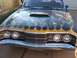 1971 Mercury Cyclone - Front view of a black car with flame graphics and a hood scoop.