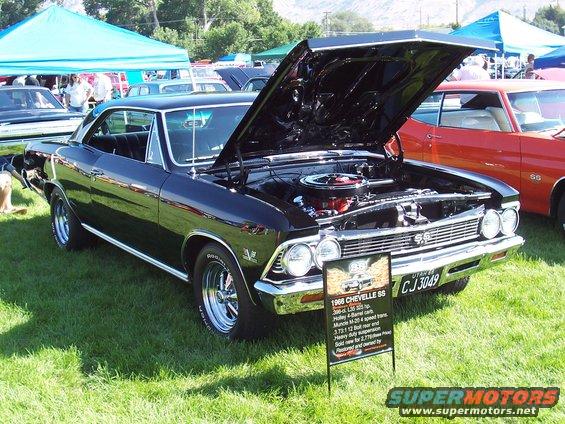 Black 1966 Chevrolet Chevelle SS, hood open, with display sign