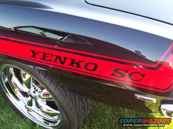 Black car side with red Yenko SC stripe and chrome wheels
