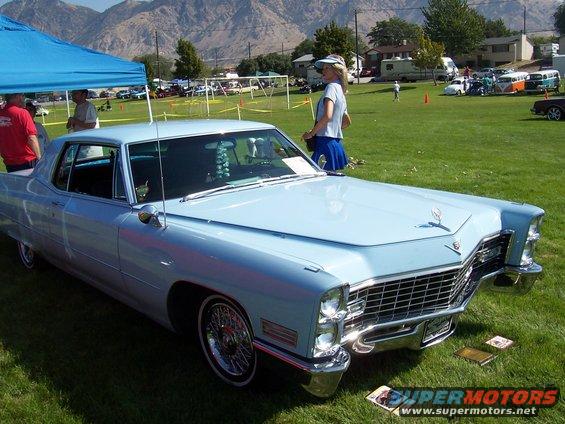 Light blue coupe with chrome grille and hood ornament. 1971 Cadillac Coupe DeVille