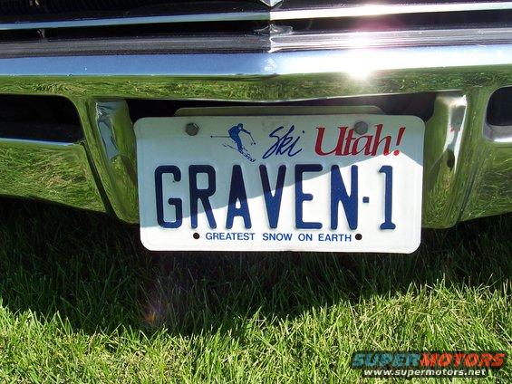 Chrome bumper with a Utah license plate reading GRAVEN-1, parked on grass