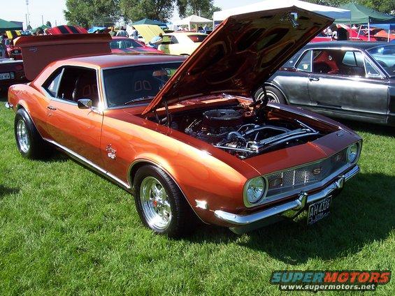 Orange 1967 Chevrolet Camaro SS with hood open, showing engine
