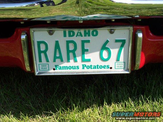Red car rear bumper with Idaho license plate 'RARE 67' and 'Famous Potatoes' text