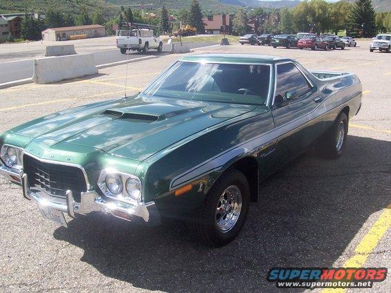 1972 Ford Ranchero parked in a lot, green paint with chrome trim and racing wheels