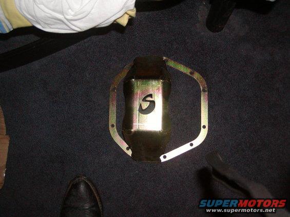 Gold oil pan with black 'S' cutout and mounting holes