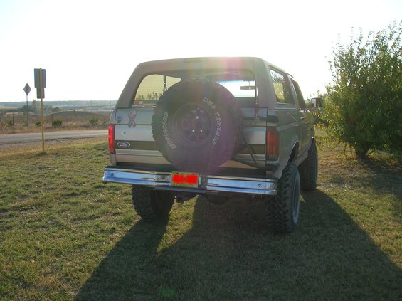 Rear view of a lifted 1996 Ford Bronco with a spare tire on the back