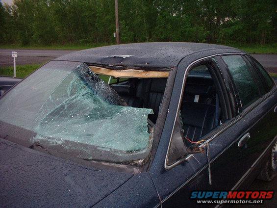 1996 Ford Crown Victoria with severely damaged roof and shattered windshield