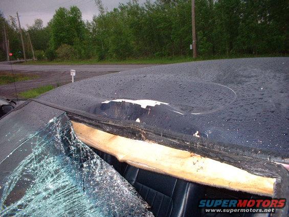 car roof is dented and windshield is shattered, showing interior and damaged headliner