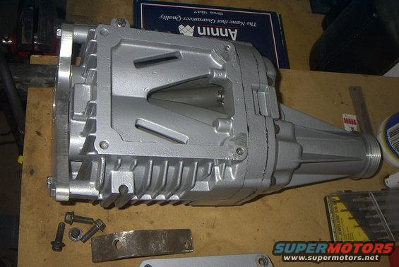 Silver supercharger with fins and mounting bolts