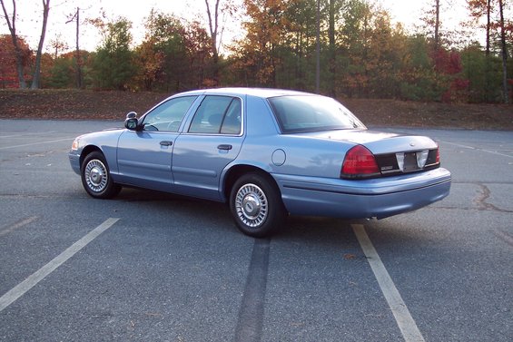 blue 2001 Ford Crown Victoria parked in a lot, rear view