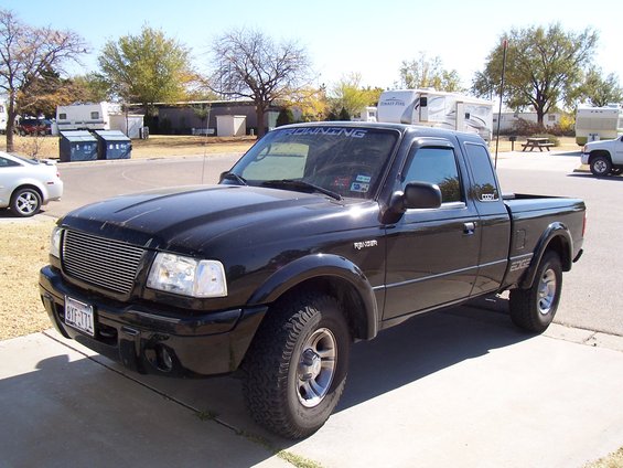 Black 2003 Ford Ranger Edge pickup truck parked on a driveway