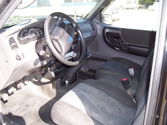 2003 Ford Ranger interior showing dashboard, steering wheel, seats, and gear shifter