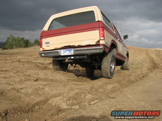 Rear view of a 1986 Ford Bronco on a dirt trail