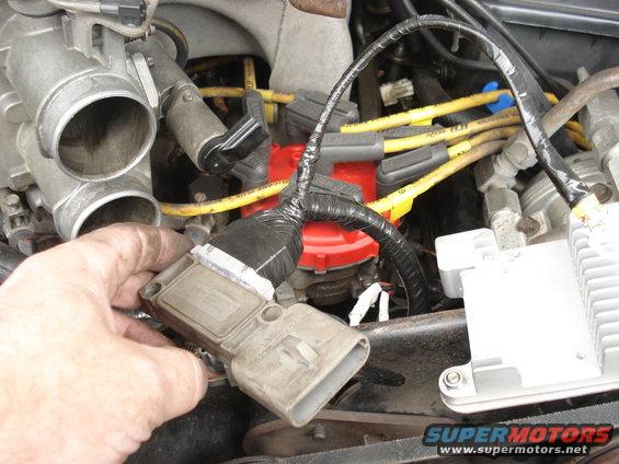 23.jpg At this point I discovered that my harness has a problem. Cables come from the dummy module connector straight back, and this makes difficult to fit the connector in the distributor because the new harness touches the coil or the main harness. If I have to do it again I'll drill a hole in the side of the module and take the cables straight up. That way it will be easier to mount the harness in the distributor. Next picture shows what I mean