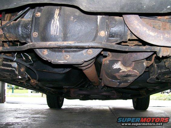 1995 Mercury Grand Marquis rear differential and exhaust system, viewed from underneath. The differential housing has white markings