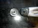 1996 Ford Bronco - Suspension part and roller bearing shown side-by-side on a dark surface.