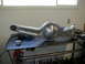 1996 Ford Bronco - A polished rear axle housing sits on a metal table, ready for installation or further work.