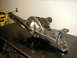 1996 Ford Bronco - A custom-modified front axle differential housing sits on a workbench, likely awaiting installation.