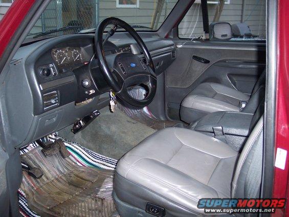 1993 Ford Bronco interior showing gray seats, dashboard, and steering wheel