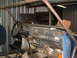 1994 Jeep YJ - The interior of a blue vehicle, modified with a roll cage, is visible from the driver's side.
