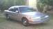 1994 Ford Crown Victoria - This 1994 Ford Crown Victoria is seen from a 3/4 front angle, parked outdoors on a grassy area.