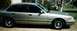 1994 Ford Crown Victoria - Side profile of a silver 1994 Ford Crown Victoria sedan parked outdoors.