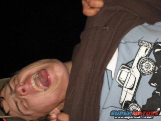 Person making a face with tongue out, wearing a shirt with a drawing of a Jeep
