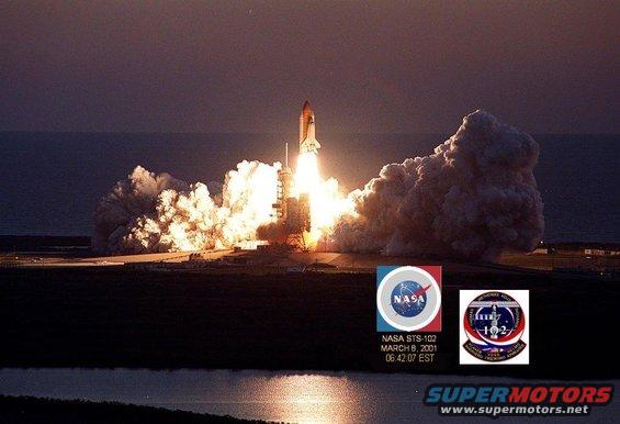 Space shuttle launch with NASA STS-102 mission details visible