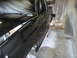 1987 Ford Bronco - A black Ford Ranger truck bed is covered in plastic and being painted in a spray booth.