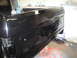 1987 Ford Bronco - Black pickup truck bed is being worked on, supported by a jack.