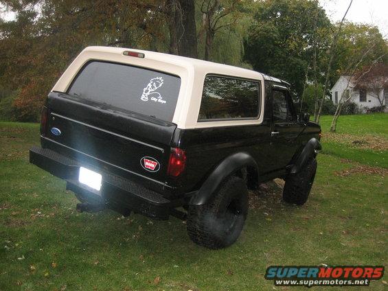 Black and tan Ford Bronco from rear-three-quarter view