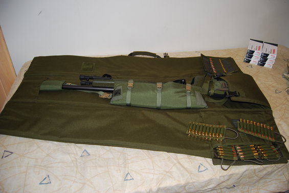 Sniper rifle with scope and ammunition in a green case