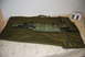 1991 Ford Bronco - A sniper rifle with a scope and multiple ammunition belts are laid out in a green carrying case.