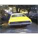 1971 Mercury Cyclone - Rear view of a yellow coupe with horizontal taillights, parked near other vehicles.