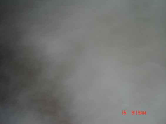 Blurry grey and brown abstract shapes with red text '15 9:19AM' in the lower right corner