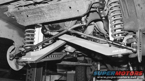 Undercarriage of a vehicle with Fabtech suspension components and visible brake assembly