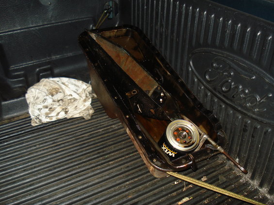 Oil pan and Wix oil filter in the bed of a Ford truck