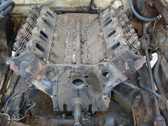 V8 engine block with cylinder heads and valve springs removed, showing internal components