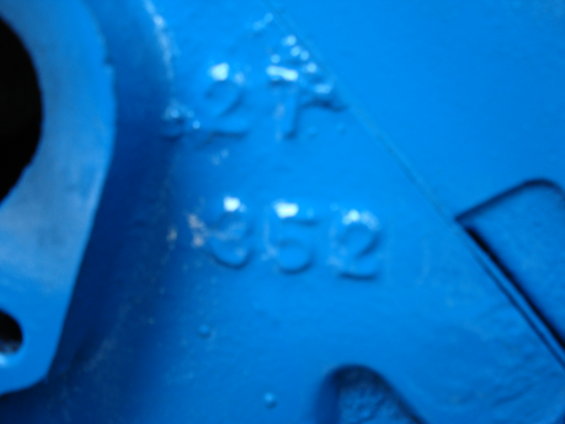 Blue painted engine part with raised numbers '27' and '352'