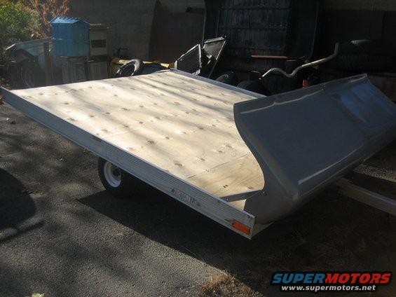 Trailer with wooden deck and gray cover